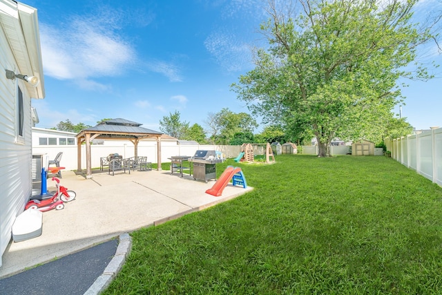 14 Crocus Ct, West Babylon, NY 11704 - fenced backyard featuring a gazebo, a playground, a storage unit, and a patio area