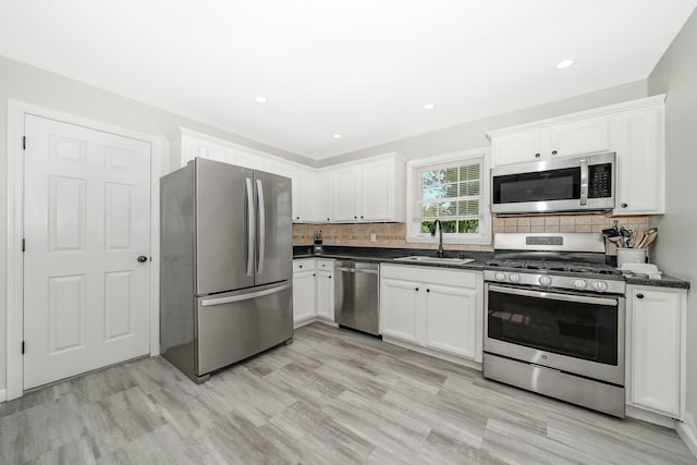 14 Crocus Ct, West Babylon, NY 11704 - kitchen with appliances with stainless steel finishes, white cabinets, backsplash, light wood finished floors, and recessed lighting