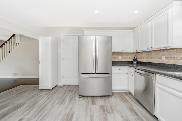 14 Crocus Ct, West Babylon, NY 11704 - kitchen featuring stainless steel appliances, dark countertops, white cabinets, and recessed lighting