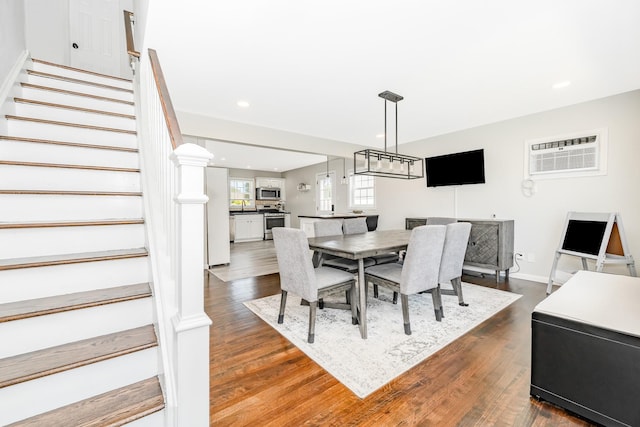 14 Crocus Ct, West Babylon, NY 11704 - dining room featuring stairs, dark wood finished floors, recessed lighting, and a wall unit AC
