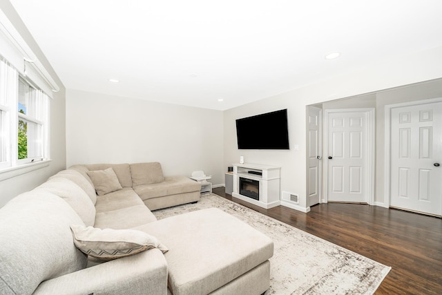 14 Crocus Ct, West Babylon, NY 11704 - living area with dark wood-style floors, recessed lighting, and a glass covered fireplace