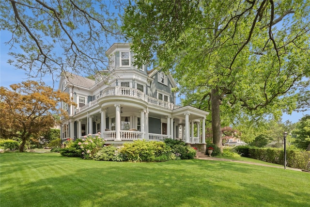 28 Shore Rd, Douglaston, NY 11363 - back of house featuring covered porch, a yard, and a balcony