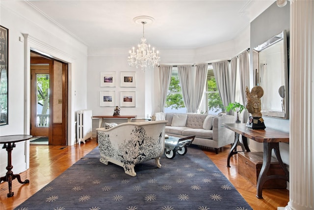 28 Shore Rd, Douglaston, NY 11363 - living area featuring radiator heating unit, a chandelier, and ornamental molding