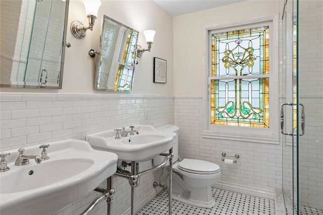 28 Shore Rd, Douglaston, NY 11363 - bathroom featuring tile walls, a stall shower, wainscoting, and tile patterned floors