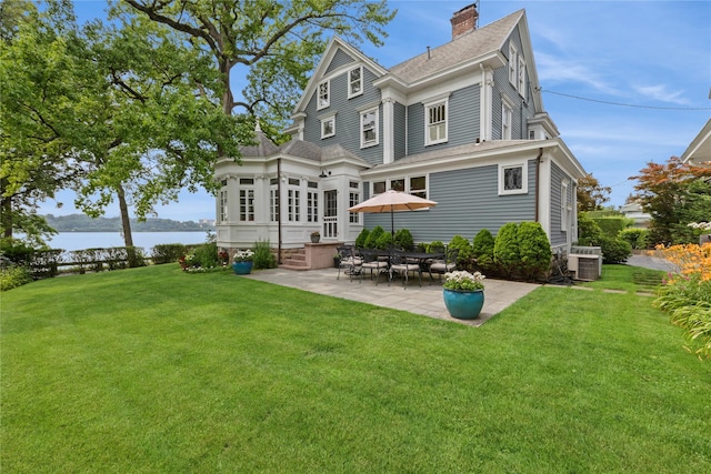 28 Shore Rd, Douglaston, NY 11363 - rear view of house with a patio area, roof with shingles, a water view, and a lawn