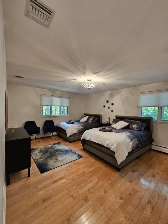 11 Cliff Ct, Monroe, NY 10950 - bedroom featuring multiple windows, hardwood / wood-style flooring, a chandelier, and baseboard heating