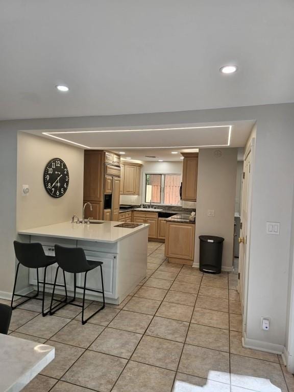 11 Cliff Ct, Monroe, NY 10950 - kitchen featuring a peninsula, recessed lighting, a kitchen breakfast bar, light tile patterned flooring, and light countertops
