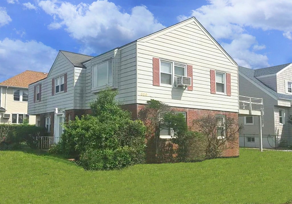 520 Lafayette Blvd, Long Beach, NY 11561 - view of side of home with a yard, brick siding, and cooling unit