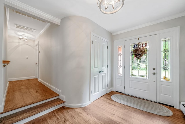 6 Memas Ct, Dix Hills, NY 11746 - entryway with vaulted ceiling, wood finished floors, a chandelier, crown molding, and a baseboard heating unit