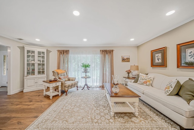 6 Memas Ct, Dix Hills, NY 11746 - living area featuring wood finished floors, crown molding, and recessed lighting