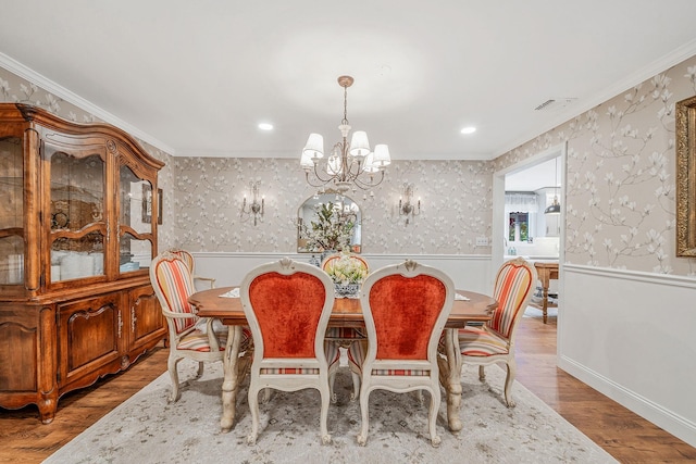 6 Memas Ct, Dix Hills, NY 11746 - dining space with a chandelier, ornamental molding, wainscoting, wood finished floors, and wallpapered walls