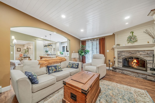 6 Memas Ct, Dix Hills, NY 11746 - living area featuring arched walkways, wood finished floors, ornamental molding, a fireplace, and recessed lighting