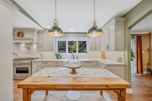 6 Memas Ct, Dix Hills, NY 11746 - kitchen with stainless steel range, light countertops, light wood-style flooring, decorative backsplash, and recessed lighting