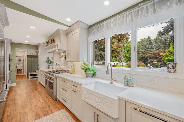 6 Memas Ct, Dix Hills, NY 11746 - kitchen featuring double oven range, decorative backsplash, light countertops, recessed lighting, and light wood-type flooring