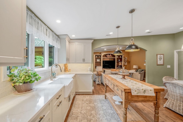 6 Memas Ct, Dix Hills, NY 11746 - kitchen with arched walkways, white cabinets, tasteful backsplash, hanging light fixtures, and recessed lighting