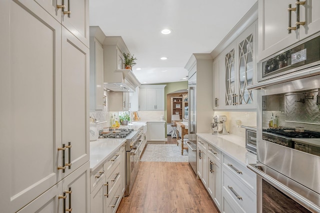 6 Memas Ct, Dix Hills, NY 11746 - kitchen with appliances with stainless steel finishes, decorative backsplash, light countertops, recessed lighting, and glass insert cabinets