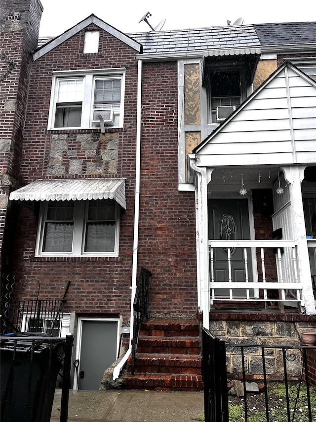82-13 32nd Ave, East Elmhurst, NY 11370 - view of front facade with brick siding and cooling unit