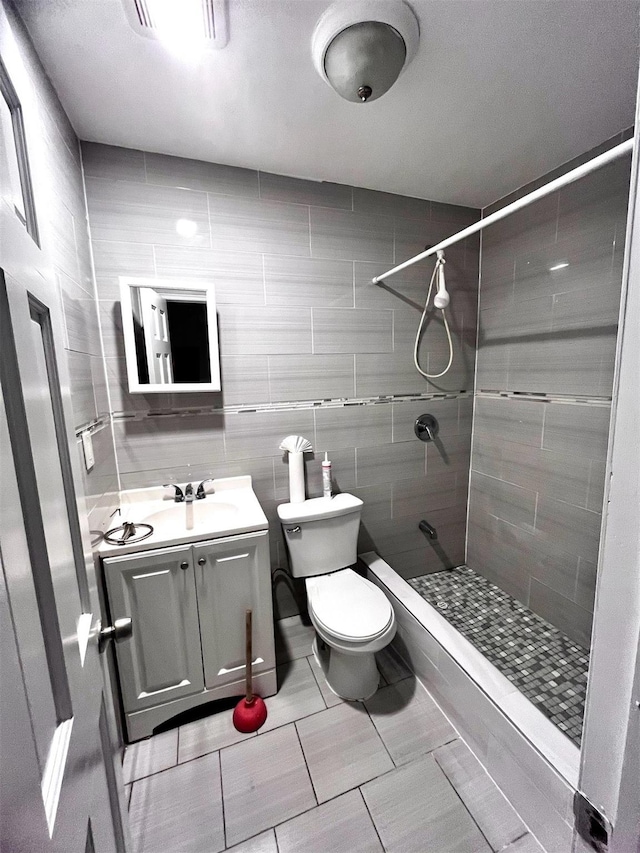 82-13 32nd Ave, East Elmhurst, NY 11370 - bathroom featuring tiled shower, vanity, and tile patterned floors