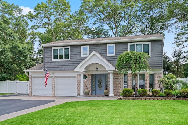 20 Tulipwood Dr, Commack, NY 11725 - view of front facade featuring asphalt driveway, brick siding, and an attached garage