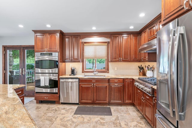 20 Tulipwood Dr, Commack, NY 11725 - kitchen featuring appliances with stainless steel finishes, under cabinet range hood, tasteful backsplash, light stone counters, and recessed lighting