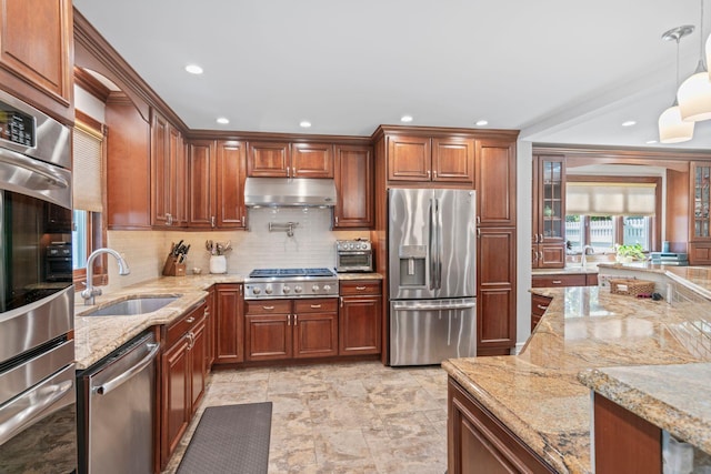 20 Tulipwood Dr, Commack, NY 11725 - kitchen featuring stainless steel appliances, under cabinet range hood, tasteful backsplash, light stone countertops, and hanging light fixtures