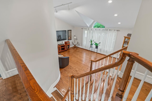 20 Tulipwood Dr, Commack, NY 11725 - stairway featuring rail lighting, lofted ceiling, wood finished floors, and recessed lighting