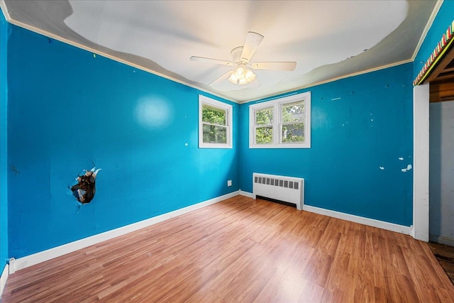 11 Bertha St, East Patchogue, NY 11772 - spare room featuring radiator, wood finished floors, and ceiling fan