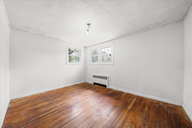 11 Bertha St, East Patchogue, NY 11772 - spare room with radiator and hardwood / wood-style floors