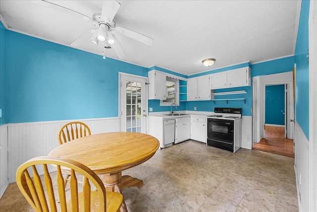 11 Bertha St, East Patchogue, NY 11772 - kitchen with gas range, dishwasher, wainscoting, light countertops, and ceiling fan