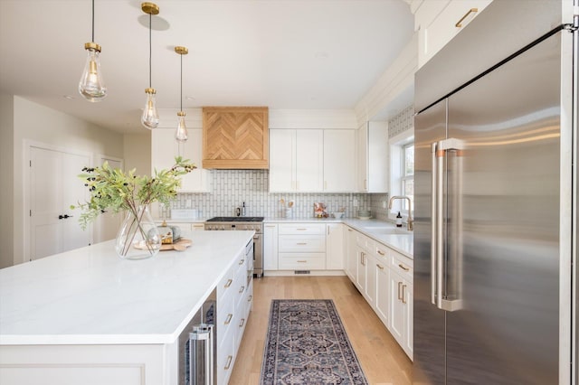 1585A Dewey Ave, North Bellmore, NY 11710 - kitchen with high quality appliances, custom exhaust hood, light countertops, and a center island
