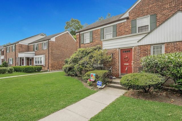 118 Robins Rd Unit 118, New Rochelle, NY 10801 - view of front of home featuring brick siding and a front yard