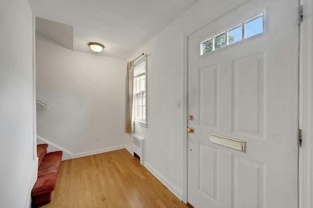 118 Robins Rd Unit 118, New Rochelle, NY 10801 - foyer with radiator, light wood-style flooring, and stairs