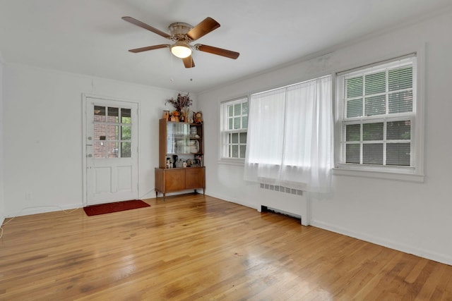 118 Robins Rd Unit 118, New Rochelle, NY 10801 - unfurnished room with radiator heating unit, light wood finished floors, and ceiling fan