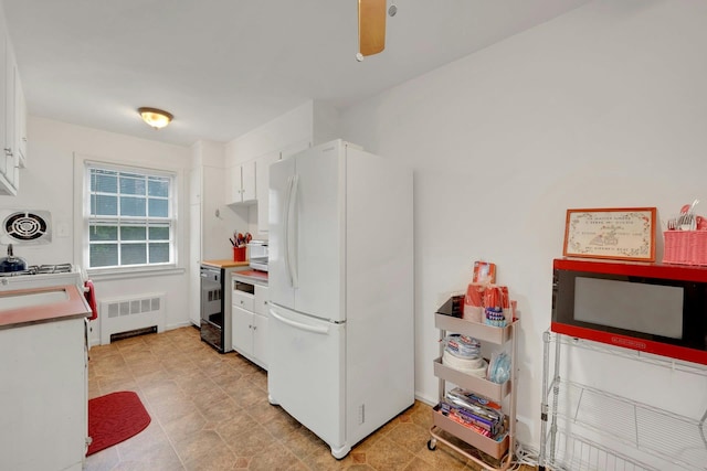118 Robins Rd Unit 118, New Rochelle, NY 10801 - kitchen with freestanding refrigerator, radiator, white cabinets, and light countertops
