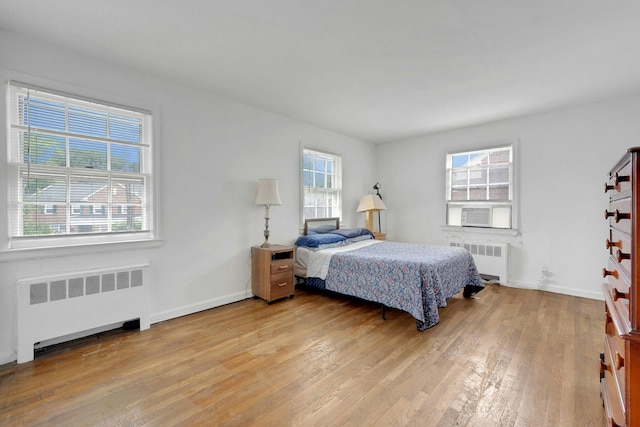 118 Robins Rd Unit 118, New Rochelle, NY 10801 - bedroom featuring radiator, light wood finished floors, and cooling unit