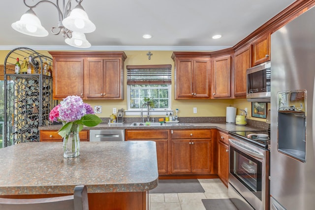 224 Moriches Middle Island Rd, Shirley, NY 11967 - kitchen with appliances with stainless steel finishes, ornamental molding, pendant lighting, brown cabinets, and a chandelier