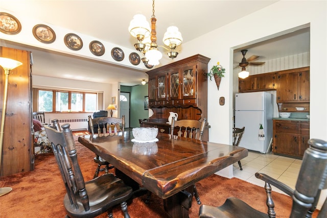 2 Nautilus Ave, Plainview, NY 11803 - dining room featuring radiator, a chandelier, light tile patterned flooring, ceiling fan, and light carpet