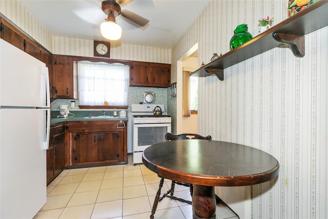 2 Nautilus Ave, Plainview, NY 11803 - kitchen featuring white appliances, wallpapered walls, a ceiling fan, light tile patterned flooring, and dark countertops