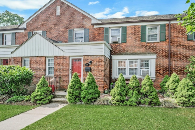 124 Robins Unit 124, New Rochelle, NY 10801 - traditional-style home featuring brick siding, a front yard, and cooling unit