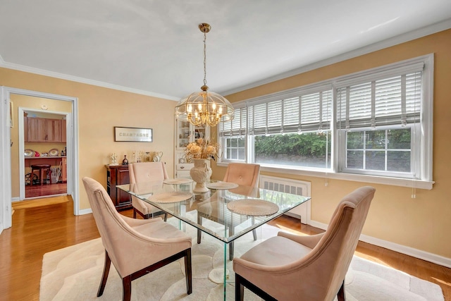 124 Robins Unit 124, New Rochelle, NY 10801 - dining area with a chandelier, wood finished floors, crown molding, and radiator