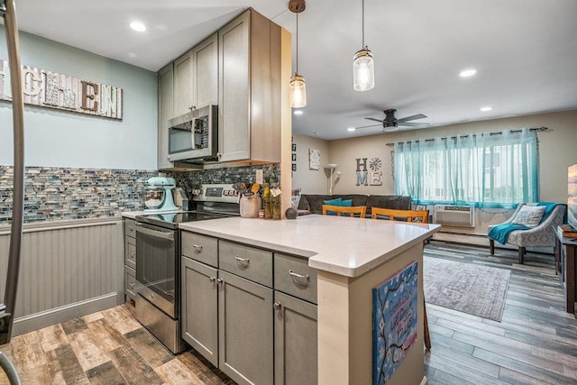 42 Richmond Blvd Unit 3B, Ronkonkoma, NY 11779 - kitchen with appliances with stainless steel finishes, open floor plan, gray cabinetry, light wood finished floors, and ceiling fan