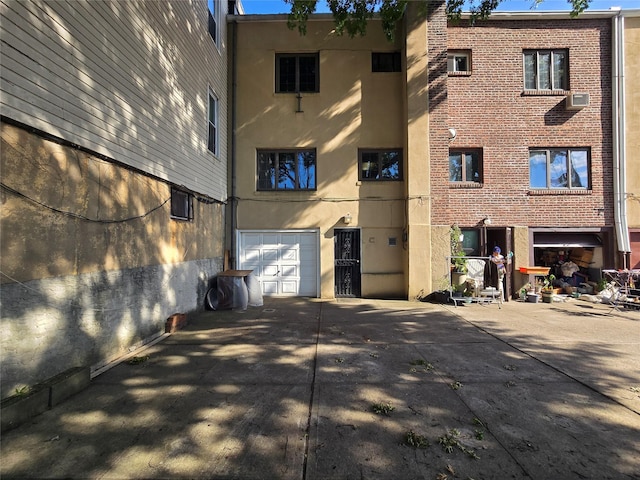 69-37 Central Ave, Glendale, NY 11385 - view of property featuring concrete driveway and a garage