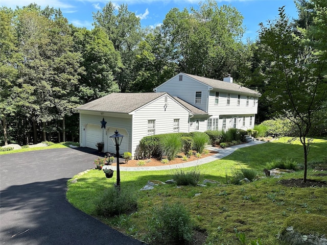 233 Upper Shad Rd, Pound Ridge, NY 10576 - view of front of property featuring driveway, an attached garage, a front lawn, a chimney, and a shingled roof
