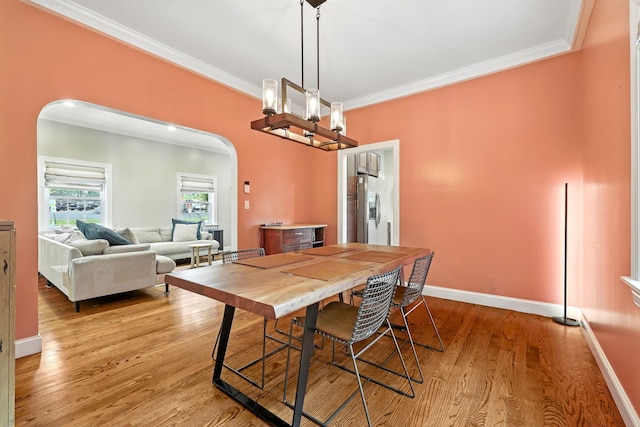 27 S Goodwin Ave, Elmsford, NY 10523 - dining area with arched walkways, crown molding, and light wood-type flooring
