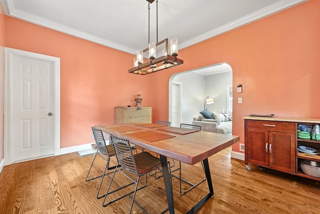 27 S Goodwin Ave, Elmsford, NY 10523 - dining space featuring arched walkways, crown molding, light wood-style flooring, and a chandelier