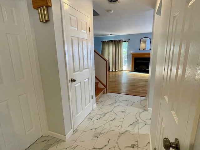 728 Woodland Estates Dr, Baldwin, NY 11510 - hallway featuring light marble finish floors and stairway