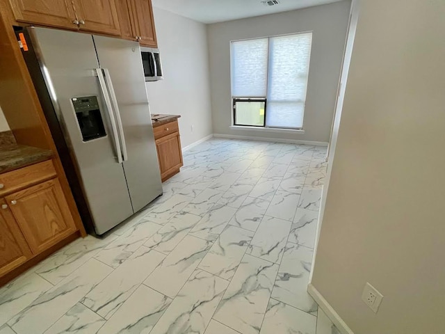 728 Woodland Estates Dr, Baldwin, NY 11510 - kitchen with stainless steel appliances, light marble finish floors, and brown cabinets