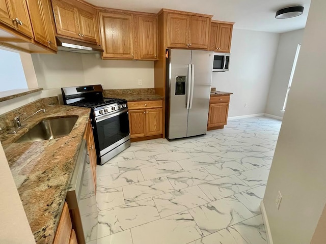 728 Woodland Estates Dr, Baldwin, NY 11510 - kitchen with appliances with stainless steel finishes, under cabinet range hood, light marble finish flooring, and brown cabinets