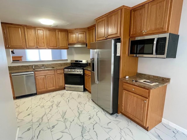 728 Woodland Estates Dr, Baldwin, NY 11510 - kitchen featuring appliances with stainless steel finishes, brown cabinetry, under cabinet range hood, and light marble finish flooring