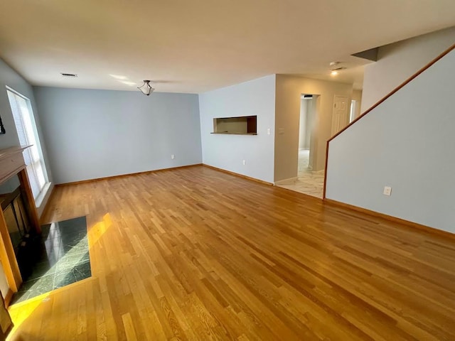 728 Woodland Estates Dr, Baldwin, NY 11510 - unfurnished living room with a tile fireplace and light wood-style floors